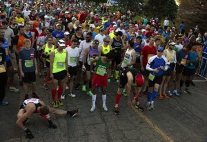 DENVER, CO - MAY 17: Taylor Ames, of Evergreen, lower left, stretches, before the start of the 10th annual Colfax Marathon which started and ended in City Park in Denver, Colorado on May 17, 2015.  The marathon started at 6:00 am.  Over 17,000 runners participated in the marathon, half marathon and 10 mile races. (Photo By Helen H. Richardson/ The Denver Post)